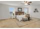 Bright main bedroom with a ceiling fan, bench, and decorative wall art at 12017 Grand Kempston Dr, Gibsonton, FL 33534