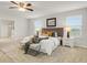 Bright main bedroom featuring a ceiling fan, plush carpet, and ensuite bathroom with walk-in shower at 12017 Grand Kempston Dr, Gibsonton, FL 33534
