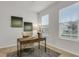 Bright home office featuring natural light, a stylish desk, and comfortable seating on soft carpet at 12017 Grand Kempston Dr, Gibsonton, FL 33534