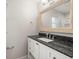 Modern bathroom with granite countertop and framed mirror at 13556 Lake Magdalene Dr, Tampa, FL 33613