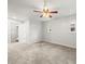 Cozy bedroom with neutral carpet, ceiling fan and two windows at 13556 Lake Magdalene Dr, Tampa, FL 33613