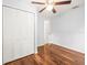 Bedroom with hardwood floors and a double door closet at 13556 Lake Magdalene Dr, Tampa, FL 33613