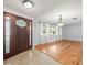 Inviting foyer features a decorative wooden door, tile flooring, and a glimpse into the spacious living area at 13556 Lake Magdalene Dr, Tampa, FL 33613