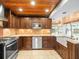 Gourmet kitchen with custom wood cabinets, granite countertops, and stainless steel appliances at 13556 Lake Magdalene Dr, Tampa, FL 33613