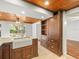 Stylish kitchen featuring a farmhouse sink, custom cabinetry, granite counters, and an open layout at 13556 Lake Magdalene Dr, Tampa, FL 33613