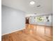 Well-lit living room featuring hardwood floors and an entry door at 13556 Lake Magdalene Dr, Tampa, FL 33613