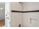 Shower featuring gray tiling and a black tile accent at 14013 Briardale Ln, Tampa, FL 33618
