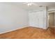 Bedroom featuring wood-look floors, one window, and a bi-fold door closet at 14013 Briardale Ln, Tampa, FL 33618