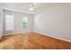 Bright bedroom with two windows, ceiling fan, and wood-look flooring at 14013 Briardale Ln, Tampa, FL 33618