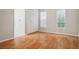 Bedroom featuring wood-look floors, two windows, and a bi-fold door closet at 14013 Briardale Ln, Tampa, FL 33618