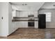 Bright kitchen featuring white cabinets, stainless steel appliances and wood-look flooring at 14013 Briardale Ln, Tampa, FL 33618