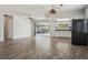 Spacious living area boasting wood-look floors, a sliding door to the patio, and kitchen access at 14013 Briardale Ln, Tampa, FL 33618