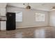Open-concept living area with wood-look floors, natural light, and kitchen access at 14013 Briardale Ln, Tampa, FL 33618