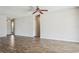 Well-lit living room with wood-look flooring and a ceiling fan at 14013 Briardale Ln, Tampa, FL 33618