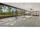 Large screened patio with patterned tile floor and ceiling fans at 14013 Briardale Ln, Tampa, FL 33618