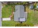 Aerial view of a neatly landscaped property with a well-maintained roof and yard at 1536 Alamo Ln, Dunedin, FL 34698