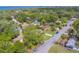 Residential neighborhood with green lawns, tree-lined streets, and sidewalks, featuring various-colored single-Gathering homes at 1536 Alamo Ln, Dunedin, FL 34698