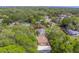 An overhead shot of a neighborhood with lovely homes and green lawns partially obscured by lush, green trees at 1536 Alamo Ln, Dunedin, FL 34698