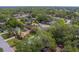 Overhead neighborhood shot featuring tree coverage and well-kept lawns and landscaping at 1536 Alamo Ln, Dunedin, FL 34698
