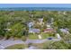 Neighborhood with a charming single-Gathering home, lush greenery and a glimpse of the water at 1536 Alamo Ln, Dunedin, FL 34698