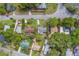 High-angle view of tidy homes with verdant lawns, complementing their neighborhood's well-maintained aesthetics at 1536 Alamo Ln, Dunedin, FL 34698
