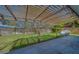 View of a backyard patio with a wooden pergola and a spacious grassy area at 1536 Alamo Ln, Dunedin, FL 34698