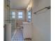 Bathroom with a glass shower door, tiled floor, a vanity with mirror, and a window allowing natural light at 1536 Alamo Ln, Dunedin, FL 34698