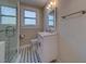 Bathroom featuring a glass shower door, tiled floor, a vanity with mirror, and a window allowing natural light at 1536 Alamo Ln, Dunedin, FL 34698