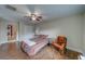 Bedroom with ceiling fan, wood flooring, closet, and natural light at 1536 Alamo Ln, Dunedin, FL 34698