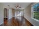 Bright bedroom featuring hardwood floors, a ceiling fan, double closets, and a double hung window at 1536 Alamo Ln, Dunedin, FL 34698