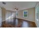 Large bedroom with wood floors, ceiling fan, and double closets at 1536 Alamo Ln, Dunedin, FL 34698