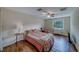 Bedroom shows wood flooring, ceiling fan, and natural light at 1536 Alamo Ln, Dunedin, FL 34698