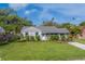 Well-maintained lawn and garden area add to the charm of this single Gathering home at 1536 Alamo Ln, Dunedin, FL 34698