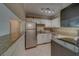 Bright kitchen features white cabinets, stainless steel appliances, granite counters, and recessed lighting at 1536 Alamo Ln, Dunedin, FL 34698