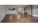Spacious living room boasts wood floors, neutral paint, and ample natural light at 1536 Alamo Ln, Dunedin, FL 34698