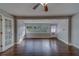 A bright living room features new wood floors, fresh neutral paint, and large windows at 1536 Alamo Ln, Dunedin, FL 34698
