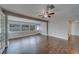 A bright living room features new wood floors, fresh neutral paint, and large windows at 1536 Alamo Ln, Dunedin, FL 34698