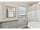 Traditional bathroom with a cabinet and bathtub and shower with white curtains at 1821 20Th N Ave, St Petersburg, FL 33713