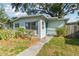 A charming single-story home with a blue front door and well-maintained landscaping at 1821 20Th N Ave, St Petersburg, FL 33713
