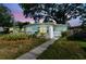 Charming single-story home featuring lush landscaping and a walkway to the front door at 1821 20Th N Ave, St Petersburg, FL 33713