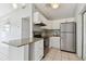 Modern kitchen featuring stainless steel appliances, white cabinets, and a peninsula counter with granite countertops at 1821 20Th N Ave, St Petersburg, FL 33713