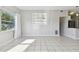 Open-concept living area with sleek tile floors, and ample natural light with a view into the kitchen at 1821 20Th N Ave, St Petersburg, FL 33713