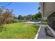 Backyard with a lawn area, pool, wood fence, and mature trees at 1842 Nebraska Ne Ave, St Petersburg, FL 33703