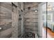 Modern shower with sleek fixtures, pebble floor, and gray stone tile at 1842 Nebraska Ne Ave, St Petersburg, FL 33703