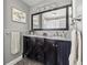 Bathroom with double vanity, framed mirror, decorative lighting, and modern fixtures at 1842 Nebraska Ne Ave, St Petersburg, FL 33703
