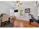 Bright bedroom set up as an office with a desk, guitar, exercise bike, and hardwood floors at 1842 Nebraska Ne Ave, St Petersburg, FL 33703