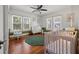 Bright Bedroom features hardwood floors, neutral walls, a ceiling fan, and a window view at 1842 Nebraska Ne Ave, St Petersburg, FL 33703