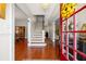 Inviting entryway featuring gleaming hardwood floors, a staircase, and views into adjacent rooms at 1842 Nebraska Ne Ave, St Petersburg, FL 33703