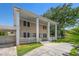 Side view of a home showing the charming covered porch, carport, and well-maintained landscaping at 1842 Nebraska Ne Ave, St Petersburg, FL 33703