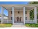 Charming two-story home featuring an inviting front porch with stately columns and a red door at 1842 Nebraska Ne Ave, St Petersburg, FL 33703
